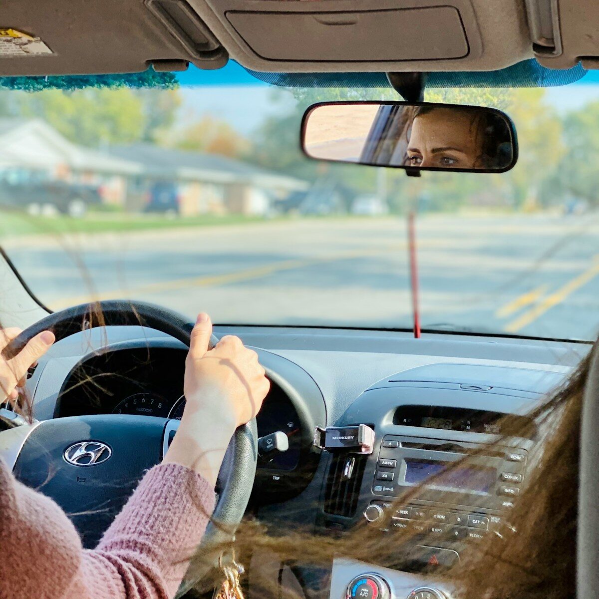 person driving car during daytime